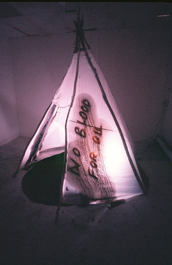 Red Breath ('no blood for oil' tipi graffiti) - live artwork by contemporary Plains Cree artist Jude Norris